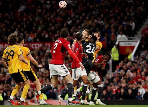 MANCHESTER, ENGLAND - AUGUST 14: Andre o<em></em>nana of Manchester United collides with Sasa Kalajdzic of Wolverhampton Wanderers during the Premier League match between Manchester United and Wolverhampton Wanderers at Old Trafford on August 14, 2023 in Manchester, England. (Photo by Jack Thomas - WWFC/Wolves via Getty Images)