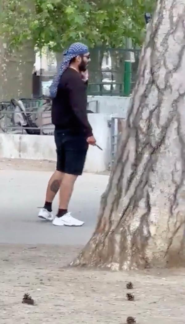 The clip ends with the knifeman leaving the play area and heading toward a grass field. 