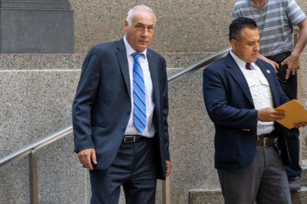 Thomas Poli, left, is pictured outside of Manhattan federal court.