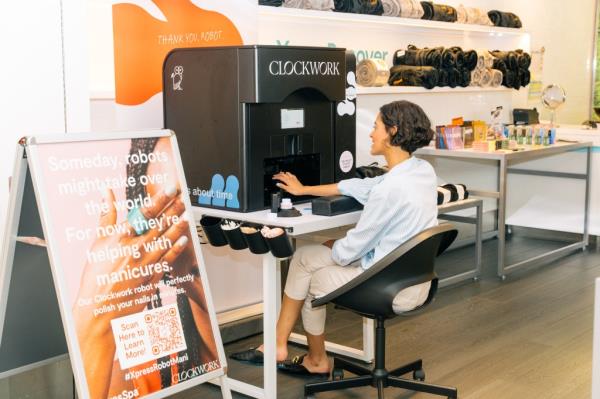 woman using Clockwork manicure machine