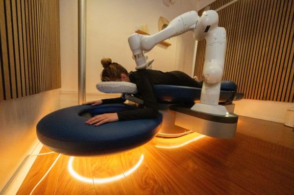 Side view of woman getting robot massage