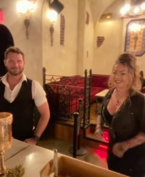 A man and woman, Anita Joy and Johnny Wactor, standing in a bar after their bartending shift