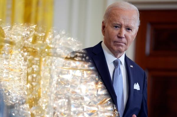 As a teleprom<em></em>pter screen reflects a chandelier light, President Joe Biden listens during a news co<em></em>nference with Kenya's President William Ruto in the East Room of the White House, Thursday, May 23, 2024, in Washington