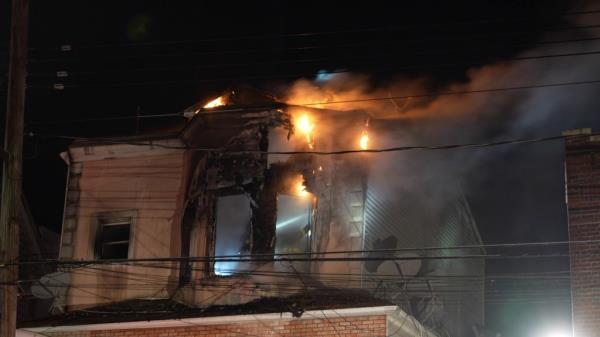 A building on fire at 1241 67 St, Dyker Heights, resulting from a house fire started by Brooklyn squatter, Cheng Chen