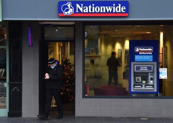 NEWCASTLE-UNDER-LYME, ENGLAND - DECEMBER 21: A man leaves a Natio<em></em>nwide store on December 21, 2021 in Newcastle-Under-Lyme, England. (Photo by Nathan Stirk/Getty Images)