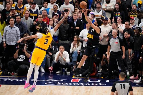 Nuggets guard Jamal Murray hits the game-winning shot over the Lakers' Anthony Davis in Game 2 of the first round on April 22, 2024.