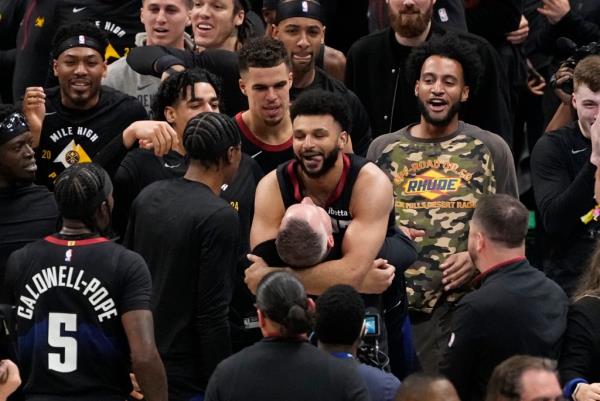 Nuggets guard Jamal Murray hugs head coach Michael Malone after hitting the game-winning shot.