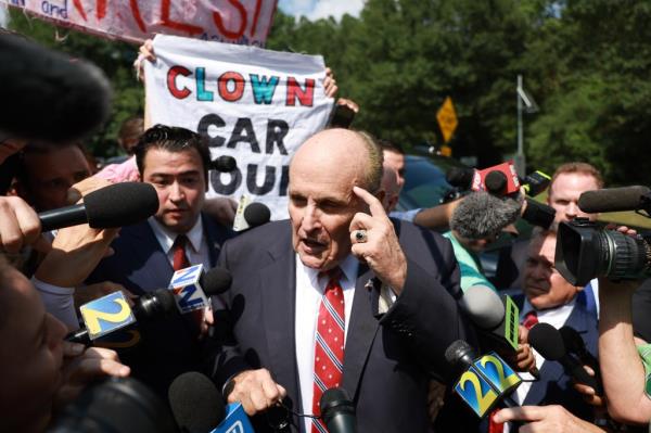 Rudy Giuliani speaks to the media after leaving the Fulton County jail.
