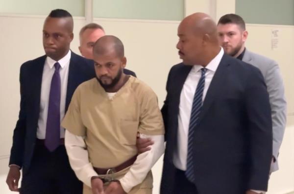 Carlisto Acevedo Brito walking into the courtroom.