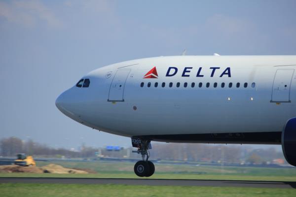 A Delta airlines flight fell into chaos after a man cut himself with a sharp object and threatened to decapitate a flight attendant.