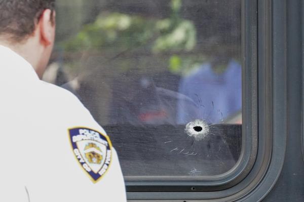 The stray bullet went through the bus' window. 
