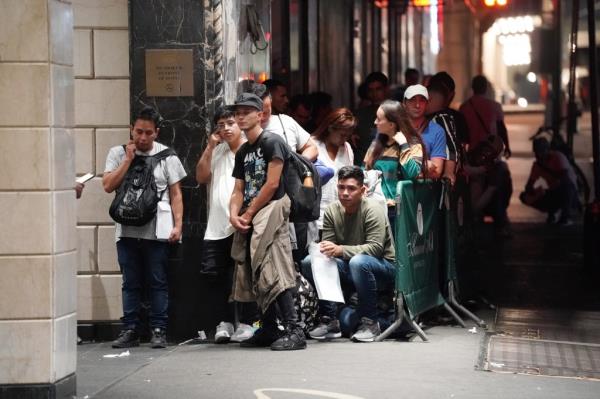 Apparent migrants and security perso<em></em>nnel seen outside of the Roosevelt Hotel in New York, NY on July 21, 2023. 