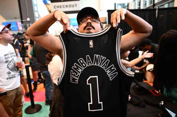 A fan displays a French basketball player Victor Wembanyama jersey after his selection as San Anto<em></em>nio Spurs's No. 1 pick during an NBA Draft Watch Party.