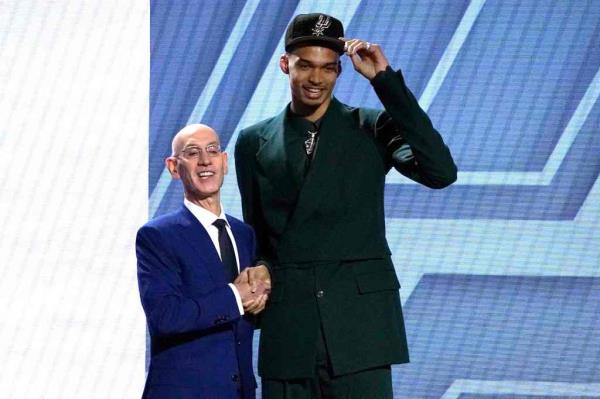 Victor Wembanyama shakes hands with NBA commissio<em></em>ner Adam Silver after being picked by the San Anto<em></em>nio Spurs during the NBA Draft at Barclays Center.