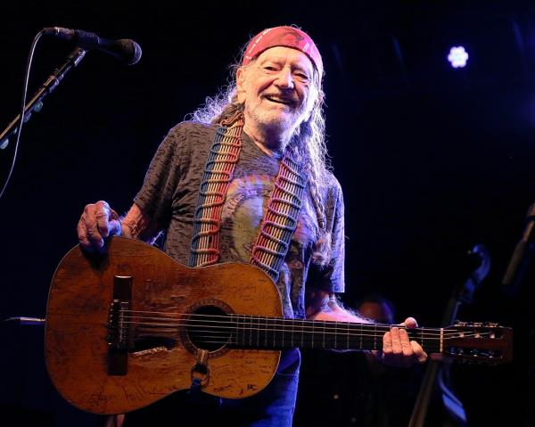 Willie Nelson playing guitar