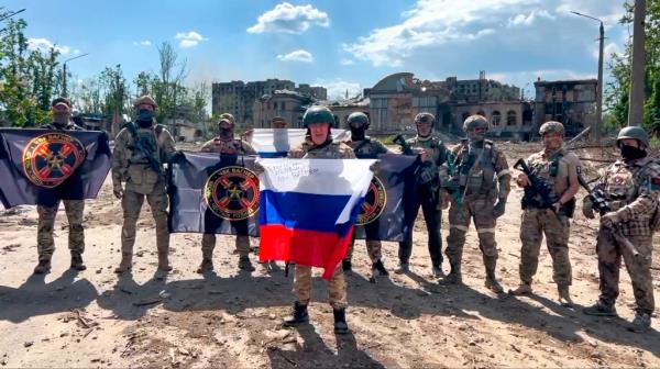 Yevgeny Prigozhin is pictured holding a Russian natio<em></em>nal flag in front of his soldiers in Bakhmut, Ukraine