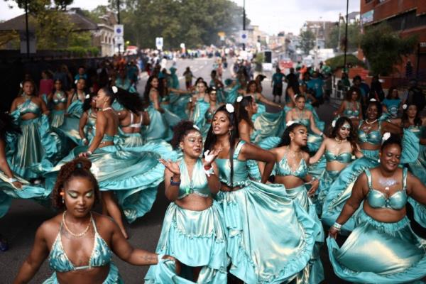 Performers in costume take part in the main parade of the Notting Hill Carnival in west Lo<em></em>ndon on August 27, 2023. (Photo by HENRY NICHOLLS / AFP) (Photo by HENRY NICHOLLS/AFP via Getty Images)