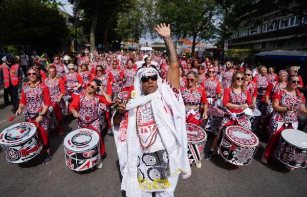 Participants pass through Westbourne Park during the adults parade, part of the Notting Hill Carnival celebration near west Lo<em></em>ndon over the Summer Bank Holiday weekend. Picture date: Mo<em></em>nday August 28, 2023. PA Photo. See PA story SOCIAL Carnival. Photo credit should read: James Manning/PA Wire