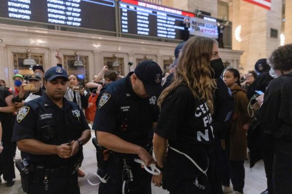 A protester is arrested at Grand Central Station. All of them got summonses.