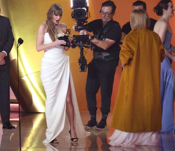 Taylor Swift holding a Grammy. 