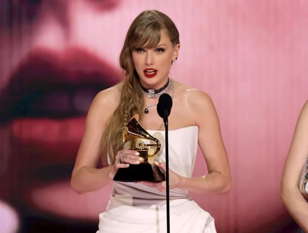 Taylor Swift holding a Grammy. 