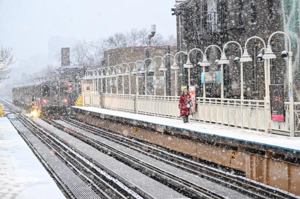 Commuter walks in Chicago subway station through snow 