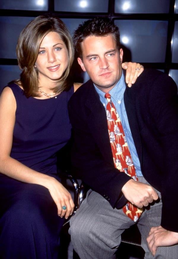Matthew Perry and Jennifer Aniston smiling together. 