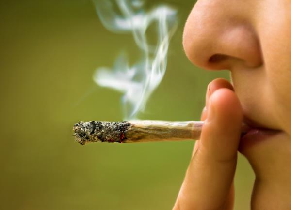 Close up of someone smoking a joint.