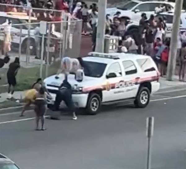 Woman twerks on top of police car 
