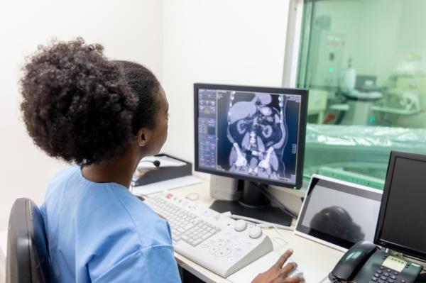 Black female radiologist looking at computer screen