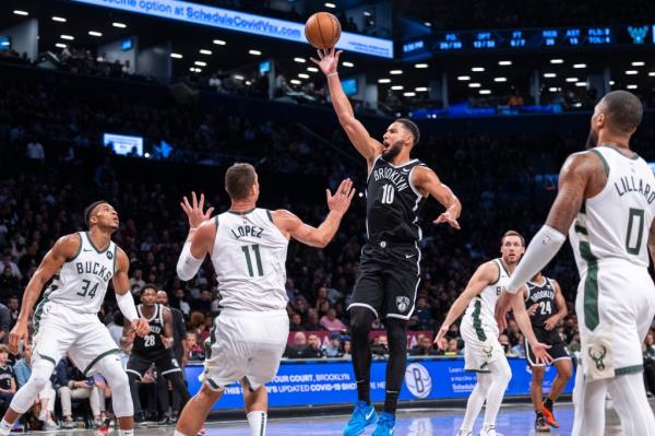 Brooklyn Nets guard Ben Simmons (10) shoots over Milwaukee Bucks center Brook Lopez (11) in the second half at Barclays Center