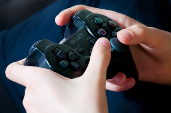 Bassano del Grappa, Italy - June, 07, 2012: Young girl's hands holding playstation wireless co<em></em>ntroller (gamepad)