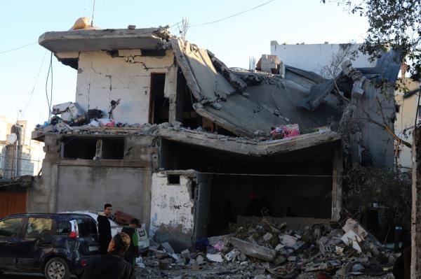 Palestinians inspect the debris of a building after Israeli airstrikes in the southern Gaza Strip city of Rafah.