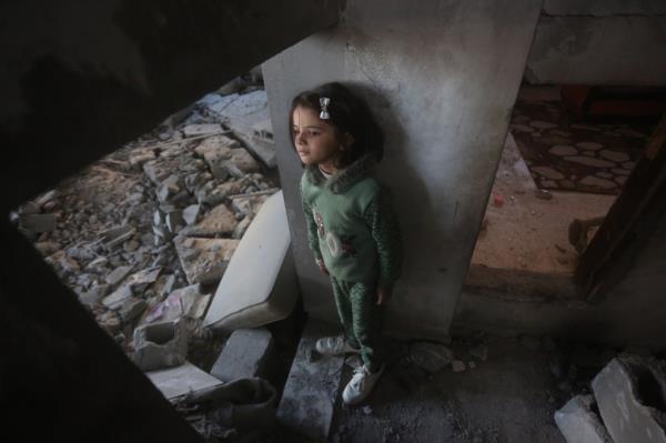 A Palestinian girl looks at the debris of a building in Rafah on Saturday.