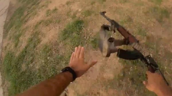 The hands of the Hamas gunman seen dropping his gun as he falls after being shot. 