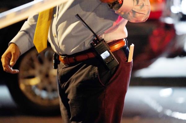 A general view of the handcuffs, gun holster, walkie talkie and badge on the belt of an NYPD detective at the scene wher<em></em>e a five year old was reportedly shot on White Plains Road at E213rd Street in the Bronx, NY