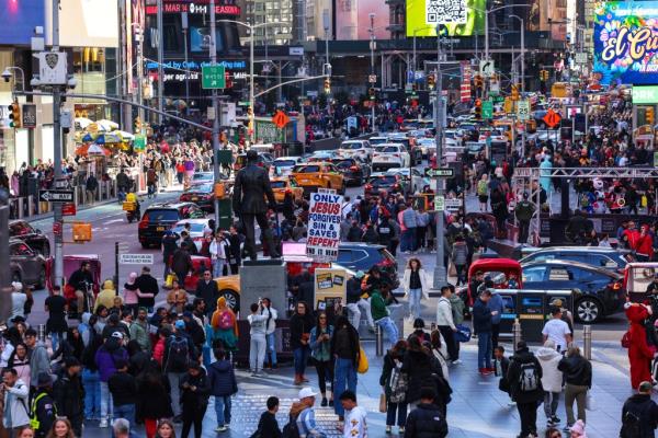 Tourists and visitors navigating through Times Square, New York City on April 7, 2024.