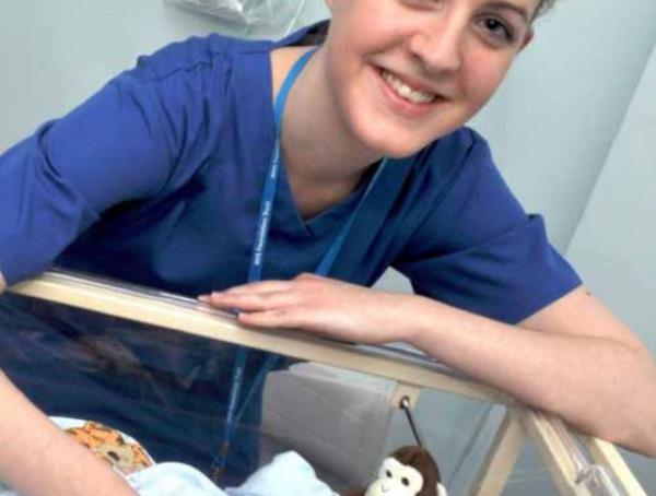 DAILY MAIL EXCLUSIVE HOLD FOR PRINT * Countess of Chester Hospital Annual Report and Accounts PAGE 13 Full page picture of Lucy Letby with a baby patient on the neo<em></em>natal unit