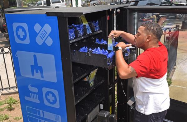 A man taking items out of one of the city's vending machines in Bushwick, Brooklyn on June 6, 2023.