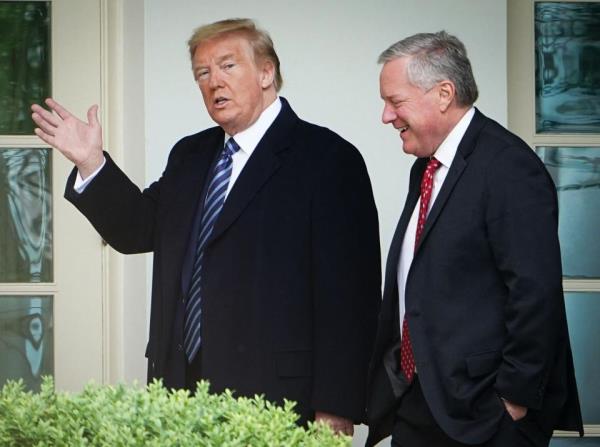 President Do<em></em>nald Trump walks with Chief of Staff Mark Meadows after returning to the White House from an event at the WWII memorial in Washington, DC on May 8, 2020.