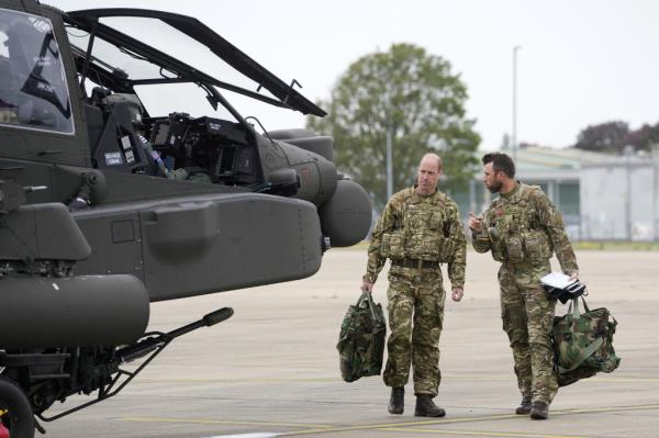 The Prince of Wales in his new role as co<em></em>lonel-in-Chief of the Army Air Corps, prepares to board an Apache attack helicopter.