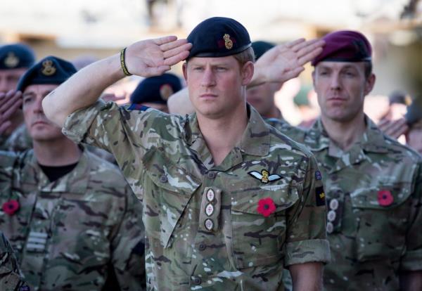 Prince Harry saluting with British troops during a Remembrance Sunday service in Kandahar, Afghanistan on November 9, 2014.