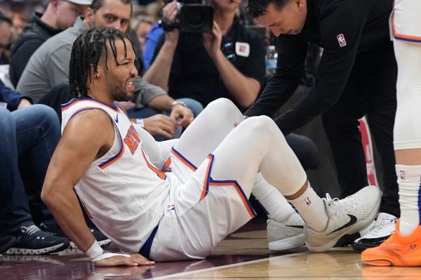 Jalen Brunson is tended to after an injury in the opening minute against the Cleveland Cavaliers. 