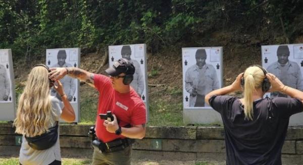 White women seen facing targets of a Black man at a range