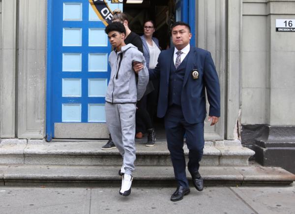 Henry Thomas is escorted from the First Precinct in Manhattan, NY