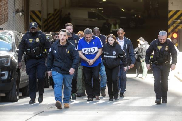 Juan Mercado getting escorted out of 26 Federal Plaza.