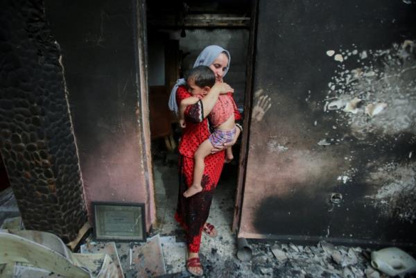 Family in a burnt down house