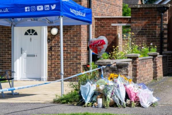 Flowers and police outside of the home to Sara Sharif, 10, who was found dead at her house in Surrey, Woking, Surrey. 15th August 2023