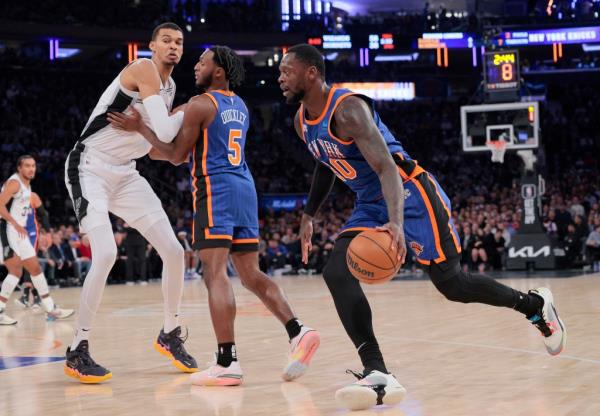 New York Knicks guard Immanuel Quickley #5 sets a pick on San Anto<em></em>nio Spurs center Victor Wembanyama #1 for New York Knicks forward Julius Randle 