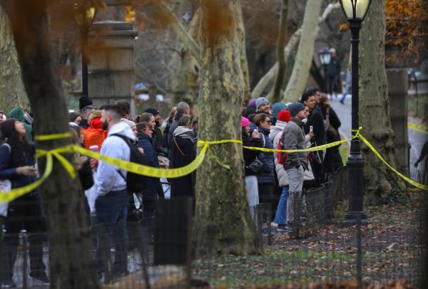 People gather around the crime scene at Heckscher Playground in Central Park.